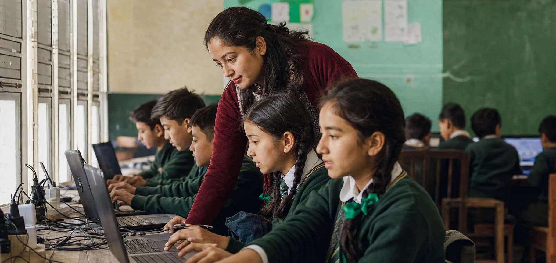 Nepali secondary school students using computers with teacher guidance
